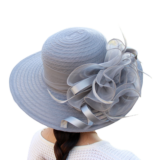 Light blue hat with decorative bow on a white background